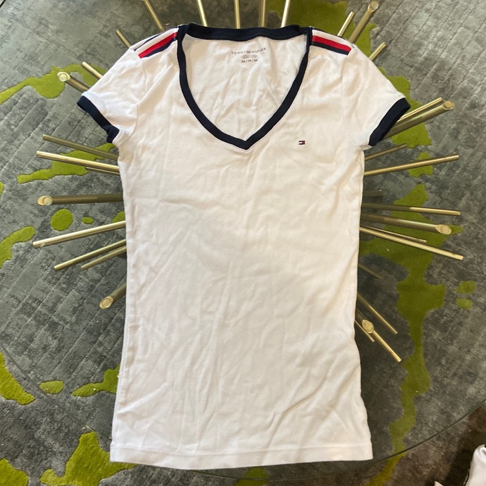 This is a xs plan Tommy Hilfiger shirt. It is white with red and blue accents.